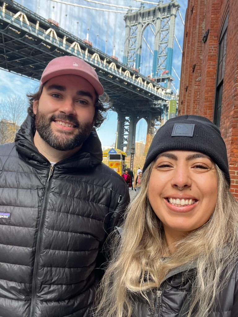 Justin Tappert and his partner, Alyssa, smile for a selfie in front of the Brooklyn Bridge on a recent trip to New York City. 